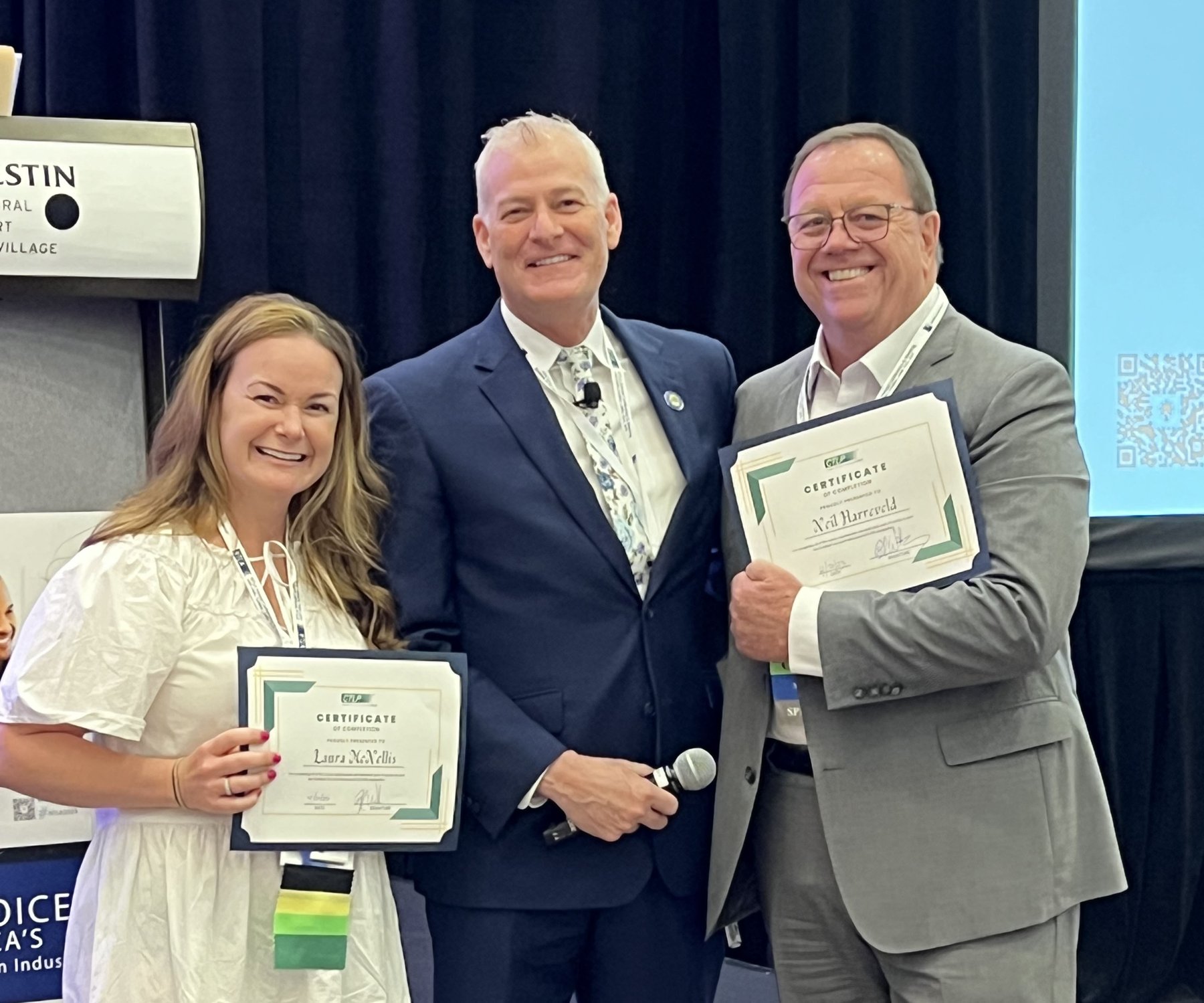Brad Westover presenting certificates of completion at an NTLA event
